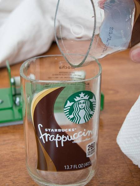 A glass tilted over another glass that says Starbucks frappuccino.