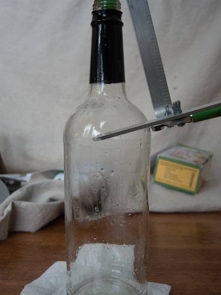 Cutting a clear glass wine bottle.