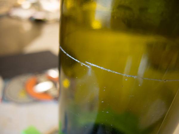 A scratch running around a green glass.