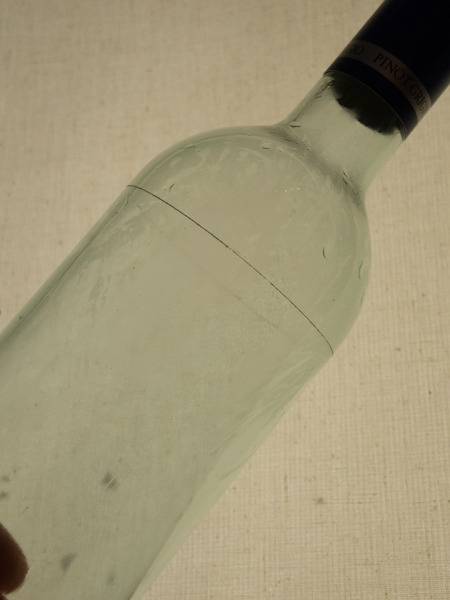 A clear bottle has a black top.