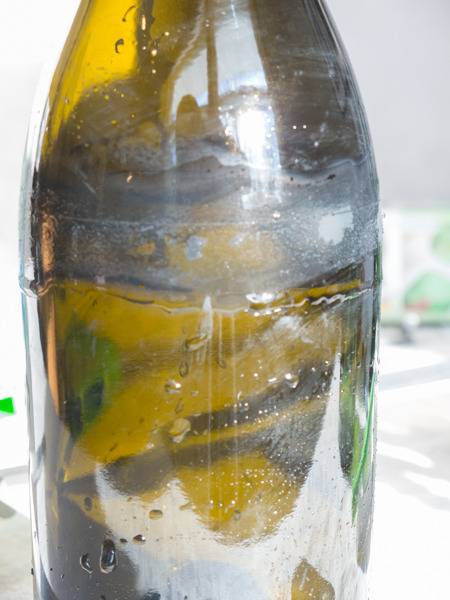 Yellowish liquid fills a bottle.