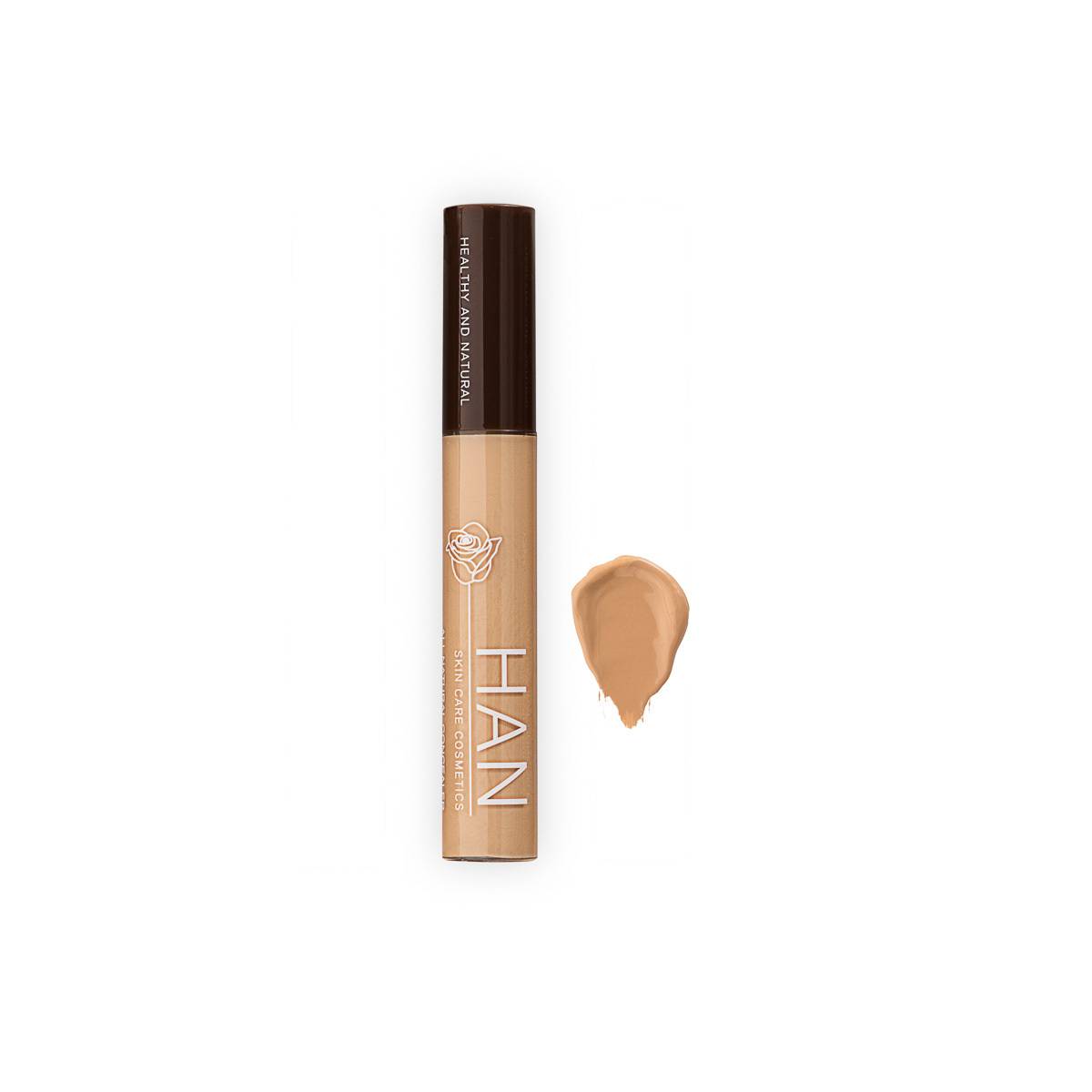 A stick of HAN concealer and a smudge of concealer next to the stick.