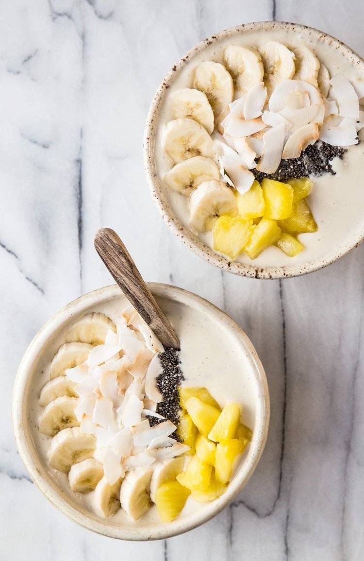 Two bowls of oatmeal with fruit