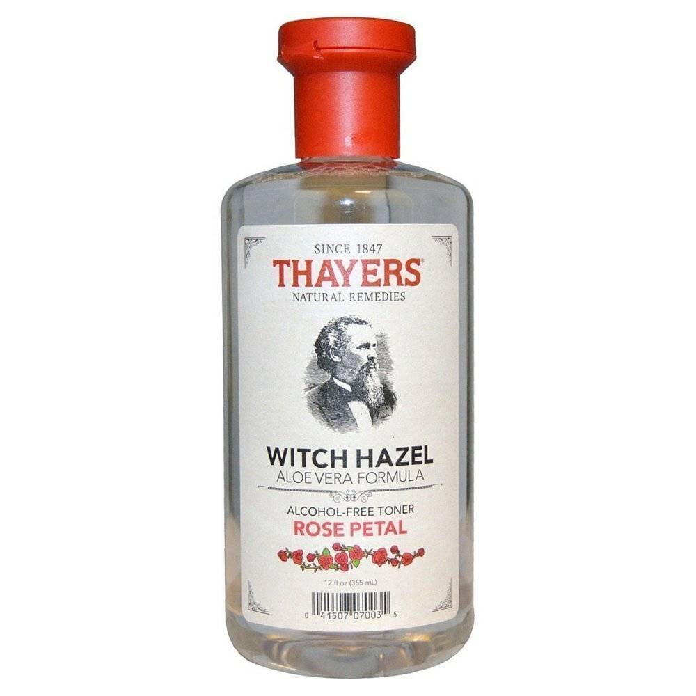 A bottle of witch hazel with a red top.