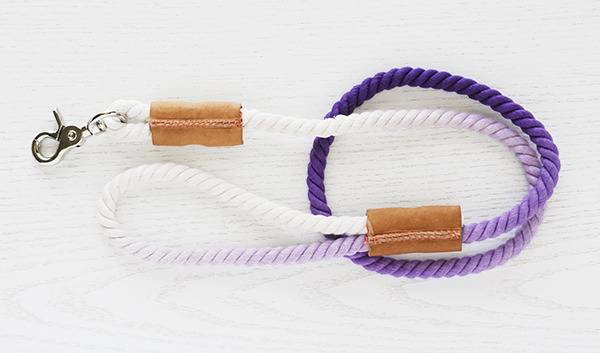 A white and purple rope with a silver hook on it.