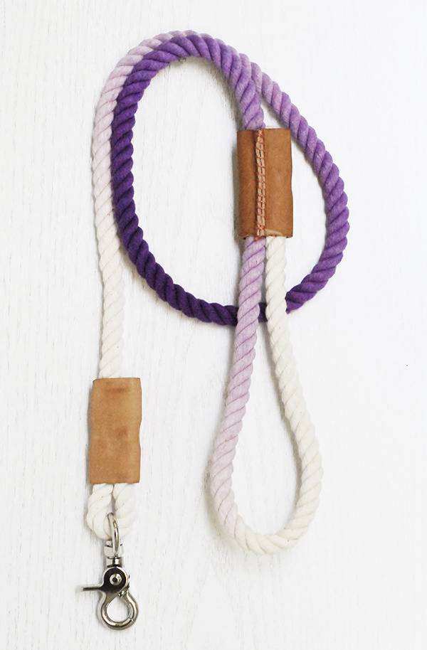 A purple and white length of rope is attached to a silver hook.