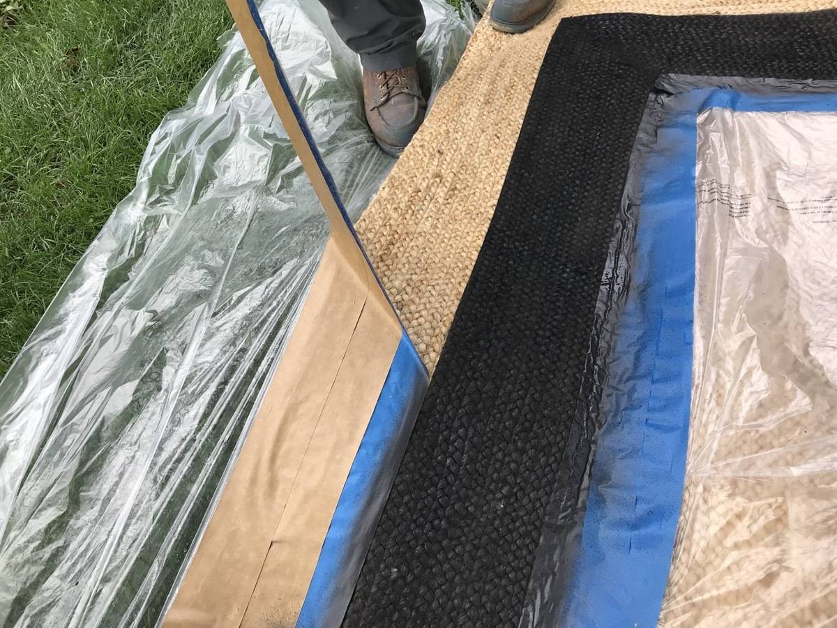 A person standing on a tarp on the ground.