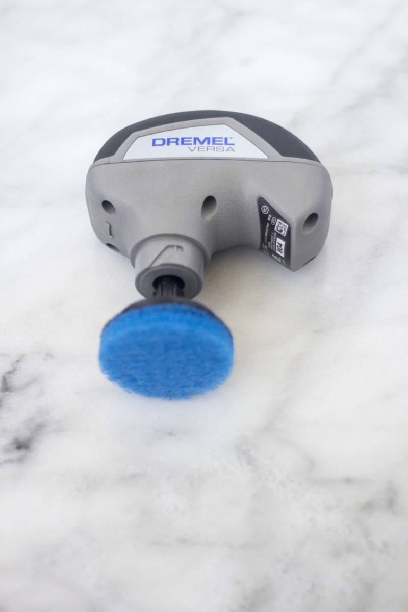 A tool has a blue knob on the end of it.