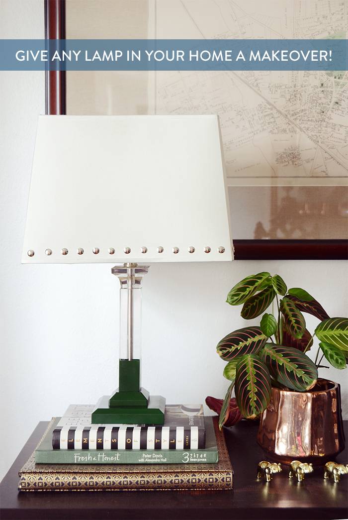 Studded lamp shade with a green base sitting on a stack of books.