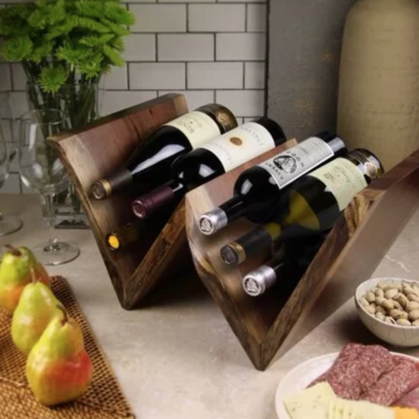 Bottles of wine set up in vee shaped wooden holders.