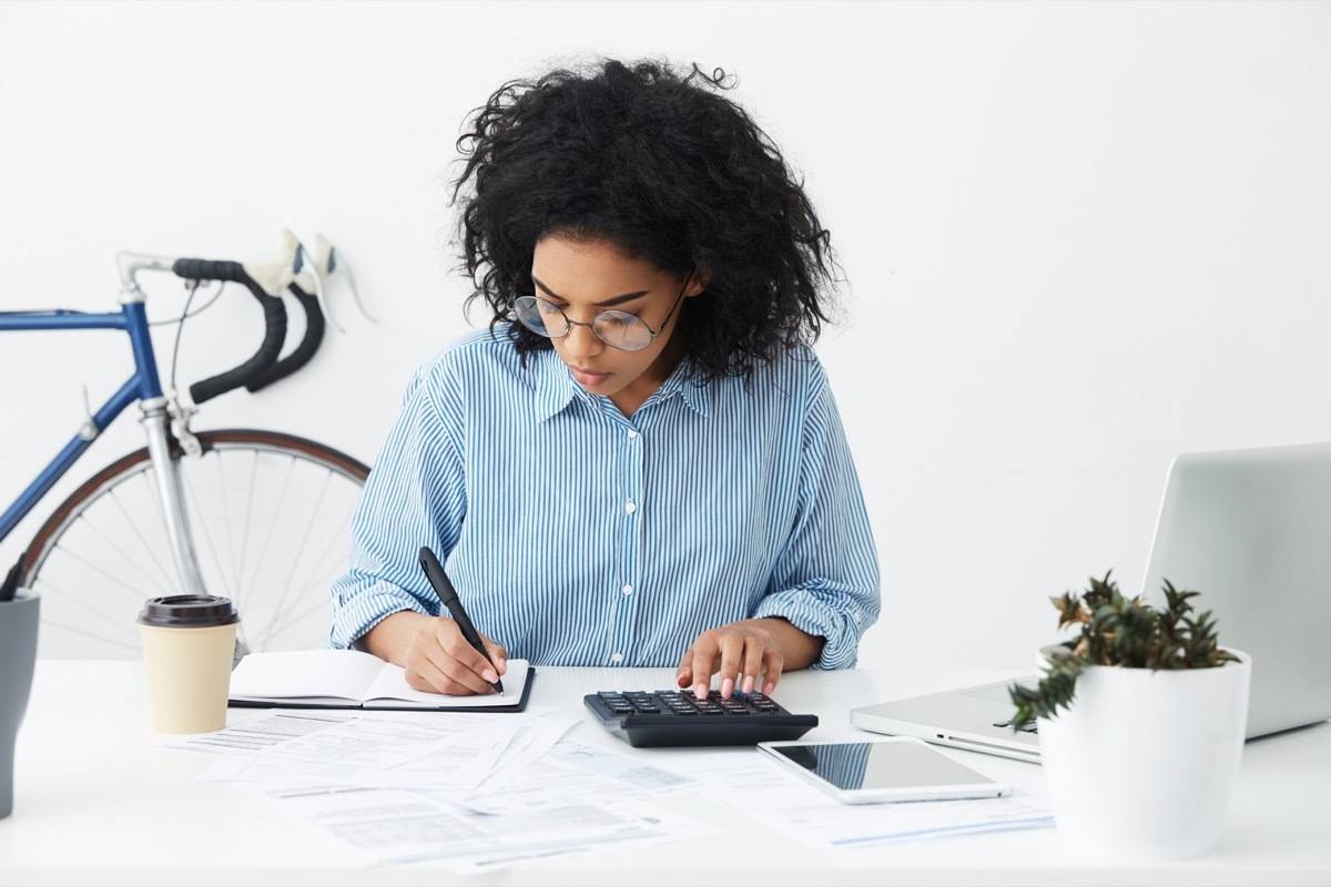 Woman using calculator