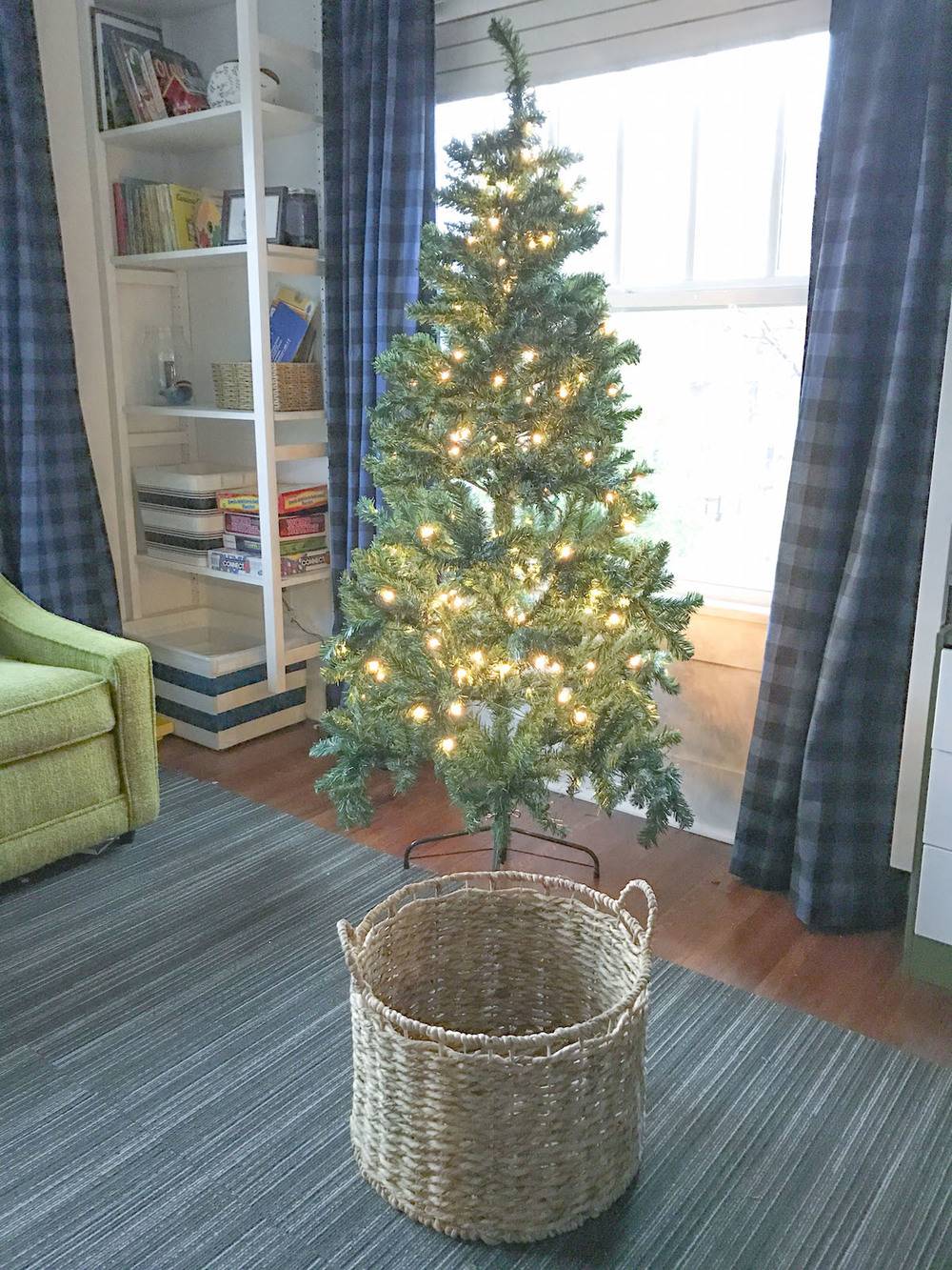 Christmas tree with wicker basket in foreground