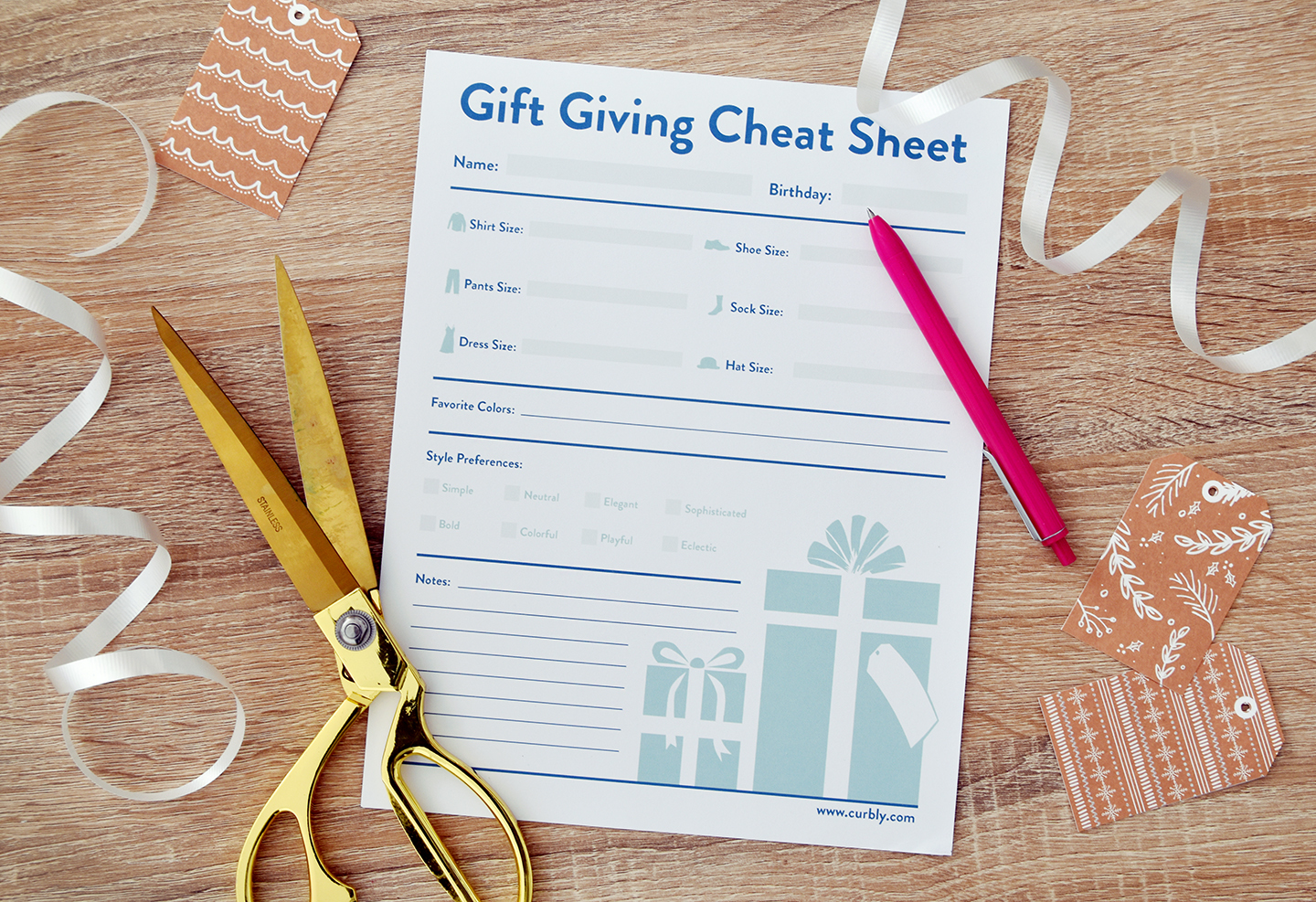Printable gift giving sheet surrounded by scissors, ribbon, and a pen.
