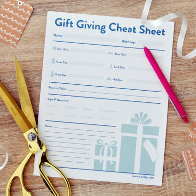 Printable gift giving sheet surrounded by scissors, ribbon, and a pen.