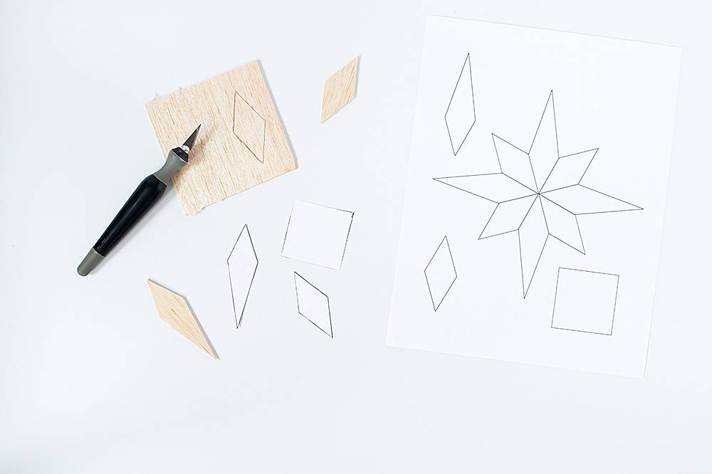 A person drawing shapes on a white paper.