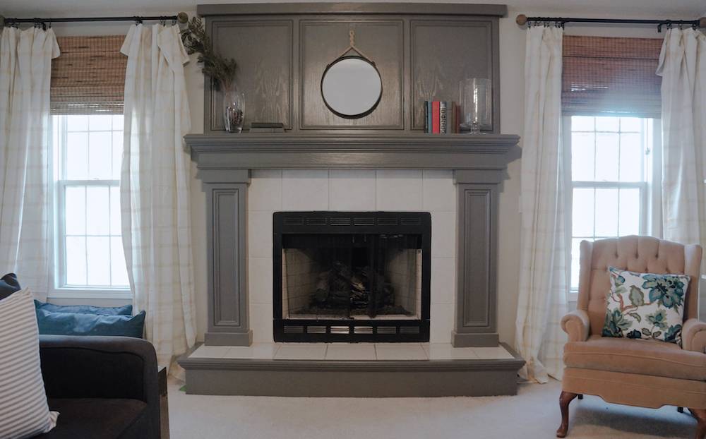 Brown and white colored fireplace with two windows on each side.