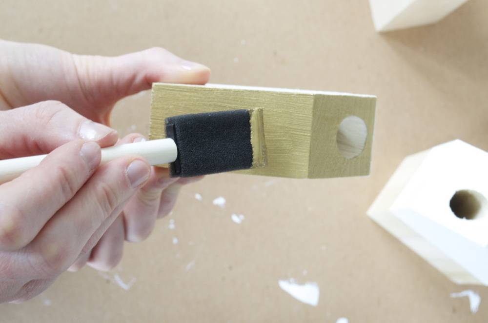 Painting a woden candle holder gold.