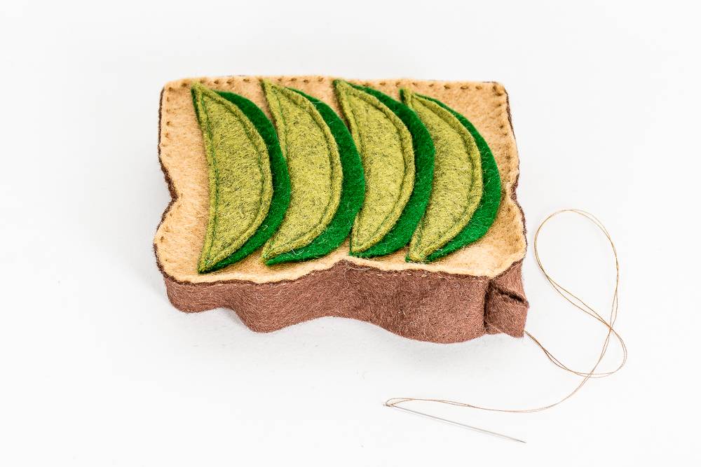 Sewing a felt avocado toast ornament