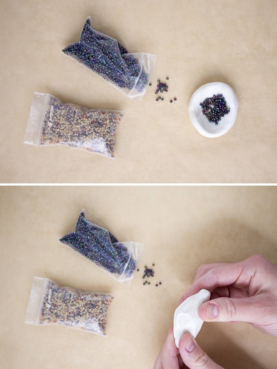 A person makes a craft using small bags with materials in them.
