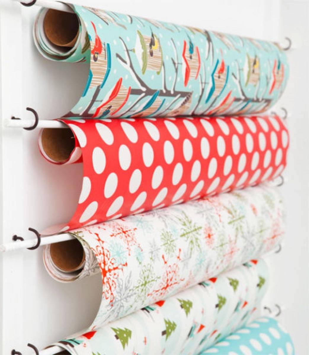 Wrapping paper can be conveniently stored on dowel rods and hooks | 72 Organization Tips and Projects for Every Space in Your Home