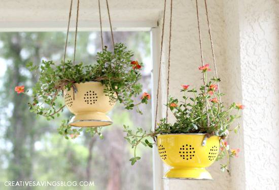Two hanging planters with flowers in them.