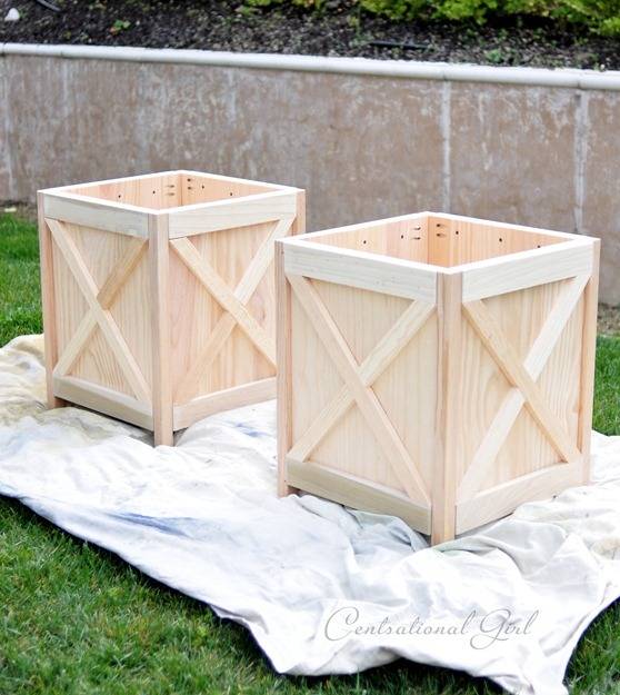 Two wooden crates sit on a tarp in the yard.