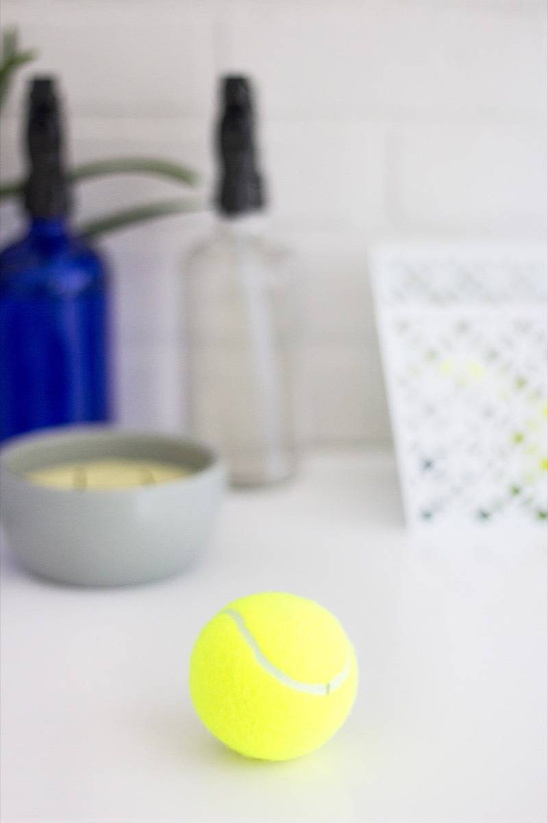 A tennis ball sits on a white counter.