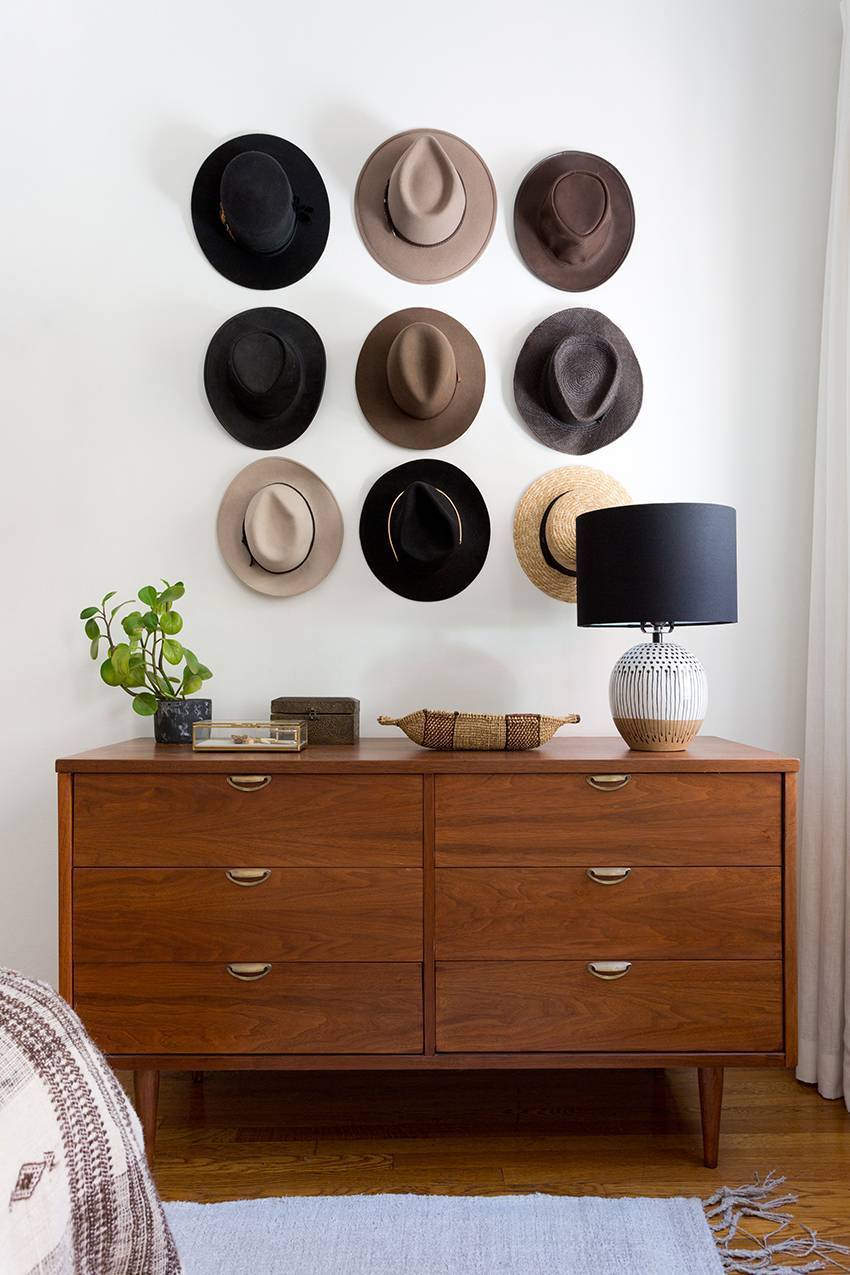 Wall decor idea using hats to create art for a bedroom room wall