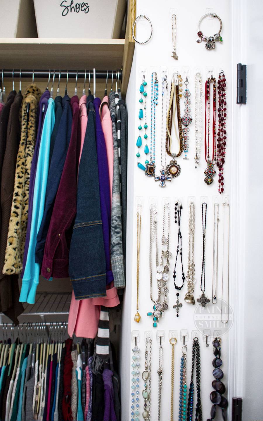 Clothing and jewelry hanging in a closet.