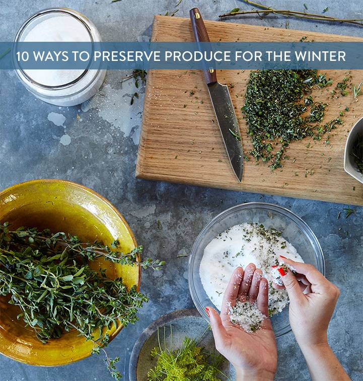 A person is preparing food using herbs and spices.