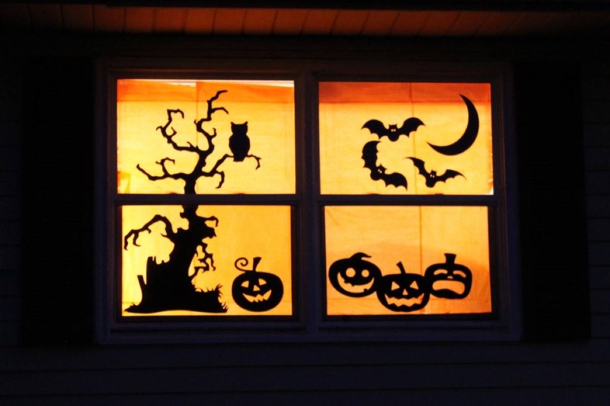 Paper silhouettes in window