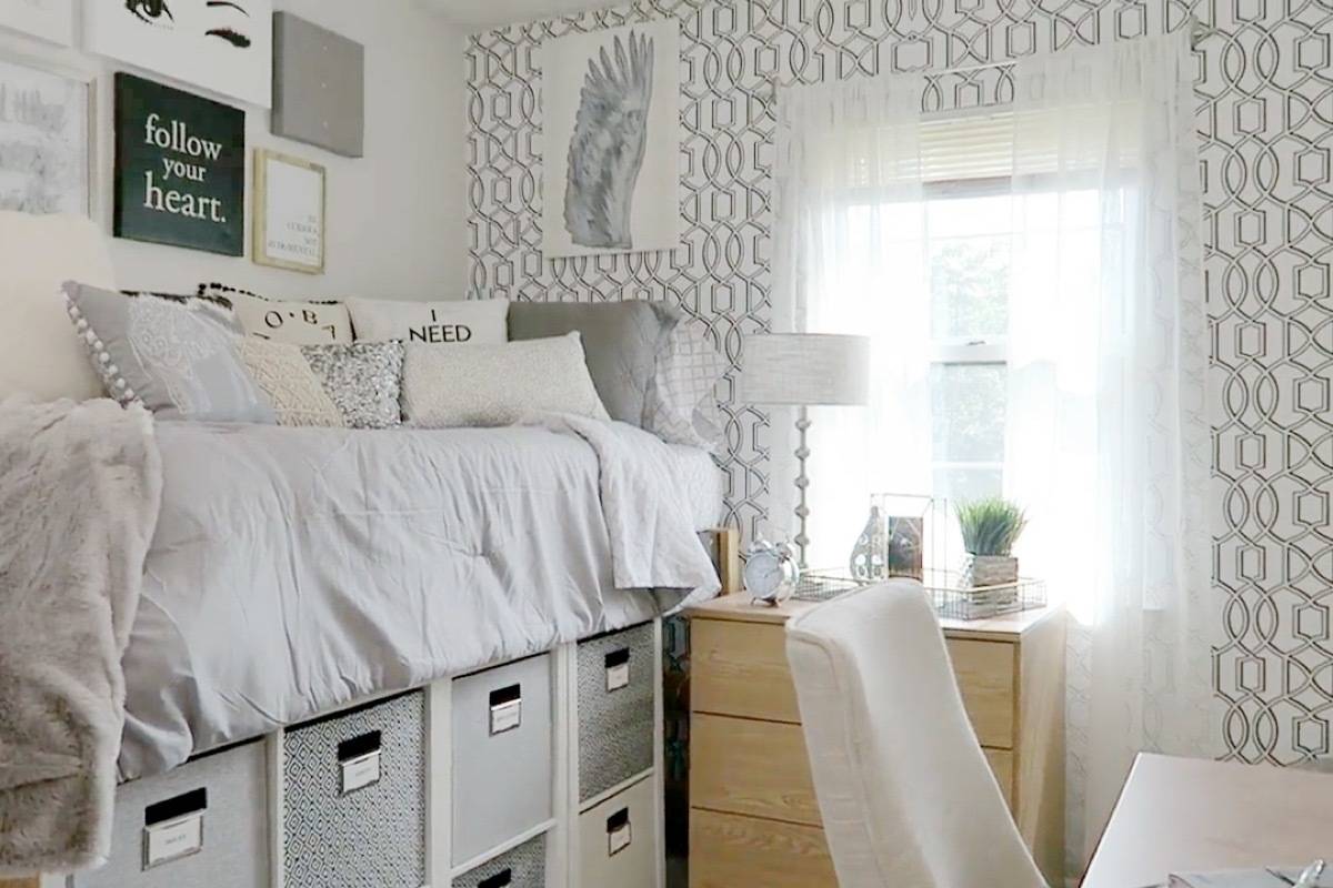 A clean well designed white and gray dorm room.
