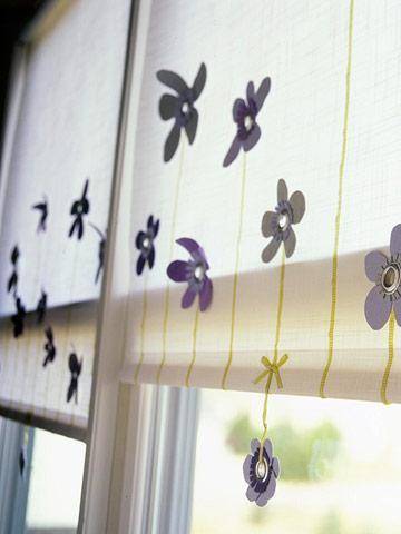 Pull down window shades are white with yellow stripes and purple flowers.