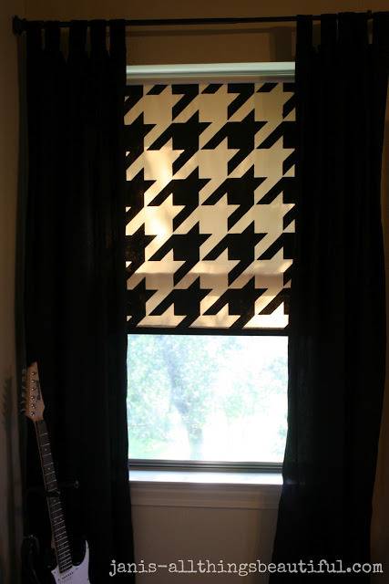 Light coming in through a window with black and white curtains.