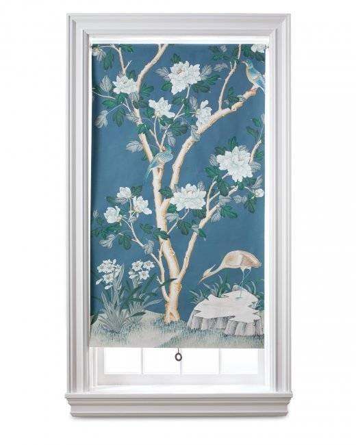 A window covered with a piece of cloth having a tree painted on it.