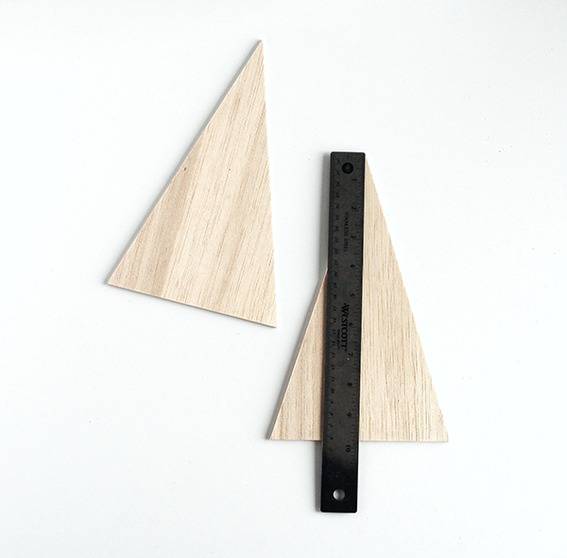 cut a triangle out of the balsa wood. Repeat this process to create a second wooden triangle