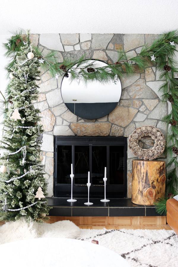 When decorating a fireplace without a mantel for Christmas, it’s our job to introduce a little structure — so the design feels balanced and easy on the eye.