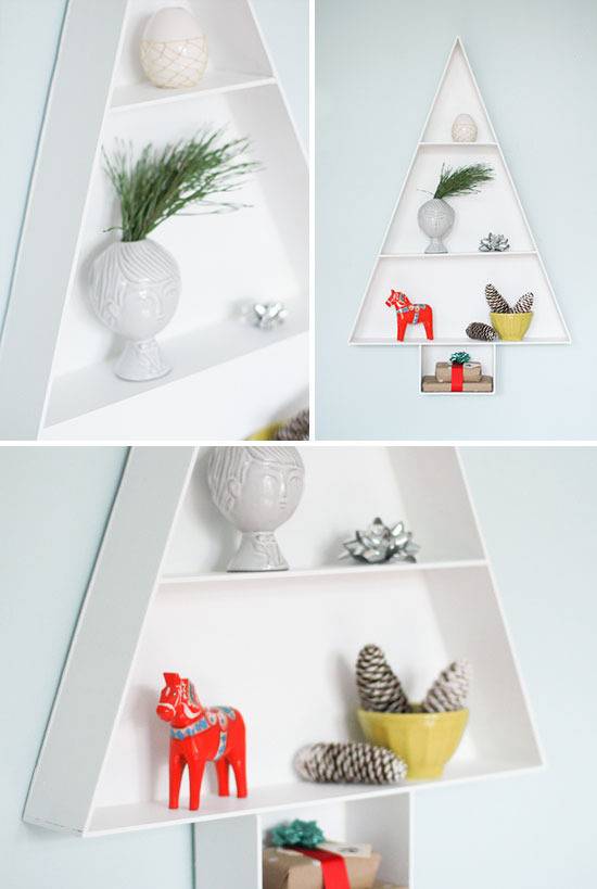 A shallow hanging wall shelf is in the shape of a pine tree.
