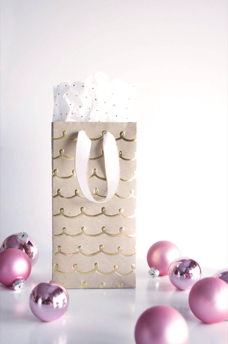 Make your own gift bags from wrapping paper, ribbon, and glue.