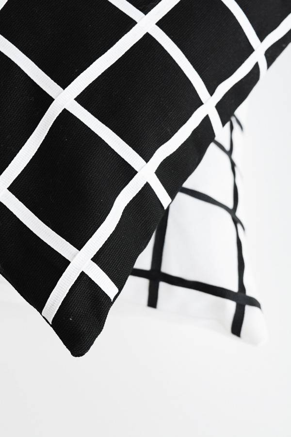 Geometric pillows that are mainly black and white.