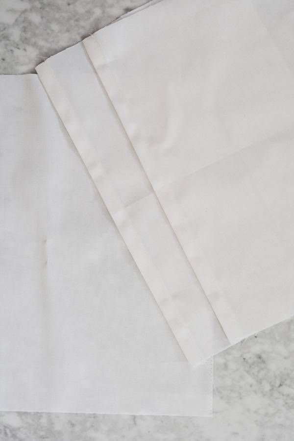 Three white square pieces of white cloth