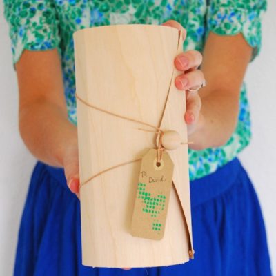 Woman holding a wooden gift box.