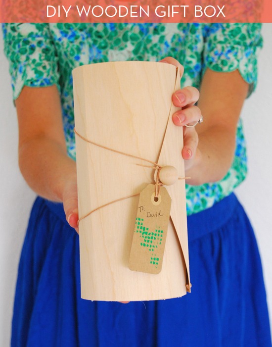 Woman holding a wooden gift box.