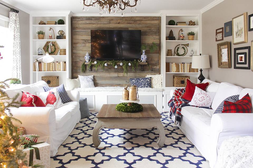 This living room is predominately white with splashes of color provided by throw pillows and a printed rug.