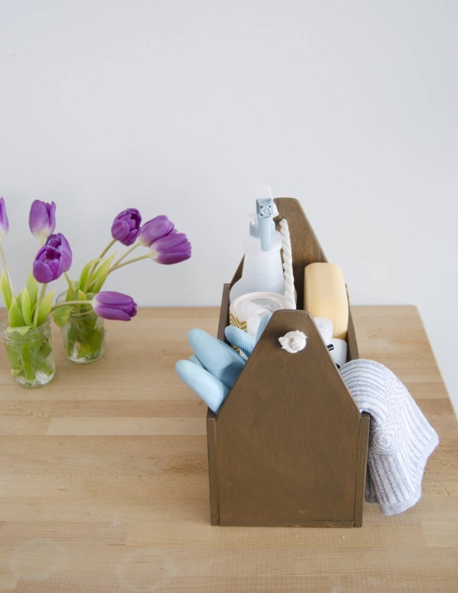 Learn how to make a handmade cleaning caddy with a few wood boards and rope.