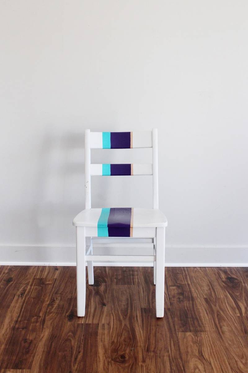 A white chair painted black and blue in the middle