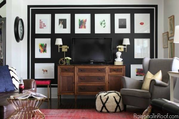 Living room featuring flat screen t.v., artwork, gray chair, and a pink area rug.