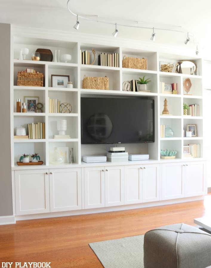 A television set into a white television set on the wall.