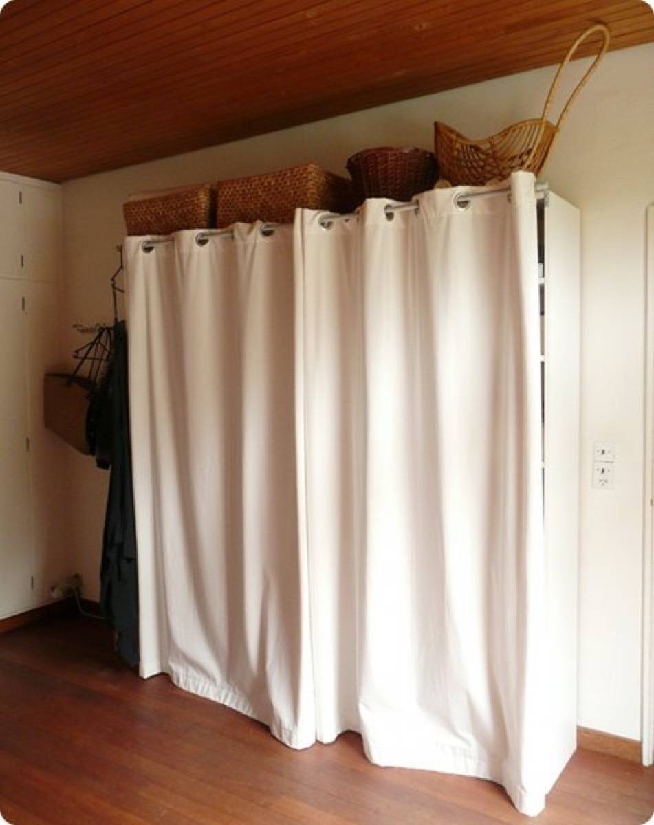 Standing closet surrounded by a curtain