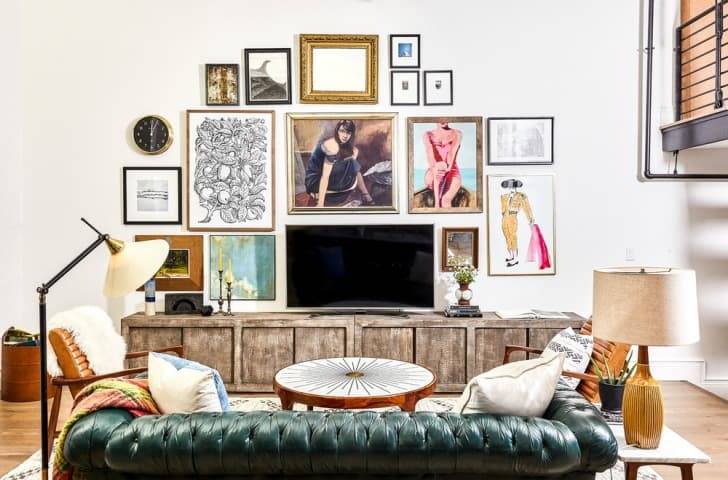 A wall is filled with different images in a dense gallery configuration.